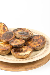 Isolated baked potatoes in the shell on the plate
