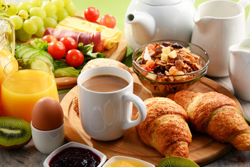 Breakfast served with coffee, orange juice, egg and fruits