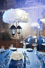 Wedding. Banquet. The chairs and round table for guests, served with cutlery and crockery and...