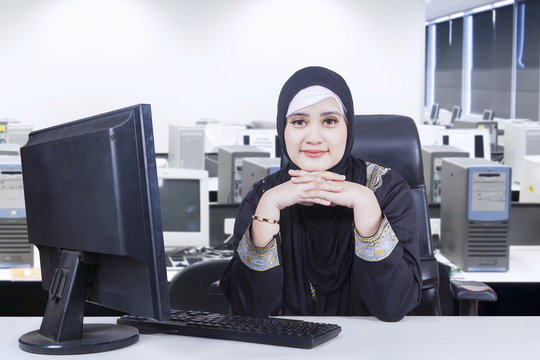 Pensive Arab businesswoman with computer