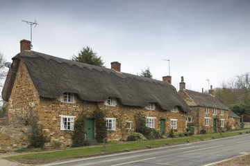 Thatches And Slates / An image of three cottages in the village of Rockingham, Northamptonshire, England, UK