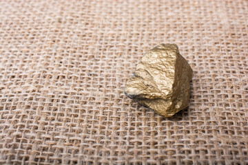 little gold color stone on a canvas