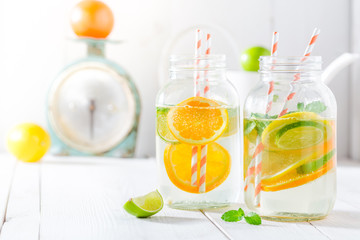 Sparkling water with citrus fruits and mint leaves