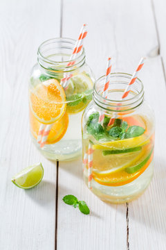 Fresh water with mint leaves and citrus fruits