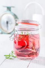 Refreshing water in jar with beetroot and rosemary