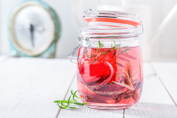 Refreshing water in jar with rosemary and beetroot