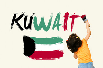 Cute little girl writing KUWAIT and drawing Kuwait Flag using painting brush on wall background