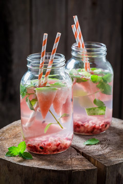Fresh water in jar with watermelon, pomegranate and mint leaves