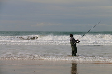 Angler fishing on the seashore