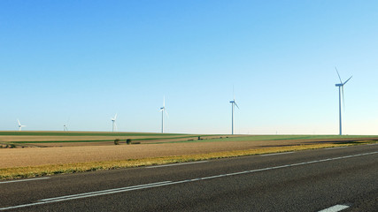 Fototapeta na wymiar Wind turbines farm using renewable energy to generate electrical power. Renewable energy is most sustainable way of power generation.