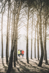 A group of athletes running in the forest.