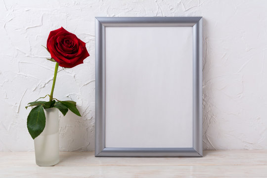 Silver frame mockup with red rose in glass vase
