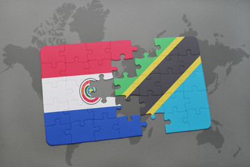 puzzle with the national flag of paraguay and tanzania on a world map