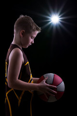 Young athlete poses with basketball