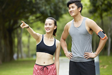 young asian couple exercising in city park
