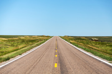 A road cutting through northern Nebraska on a summer day.