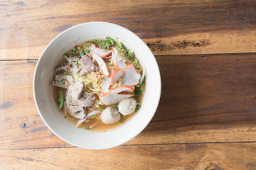Close up thai spicy pork noodle with big egg.