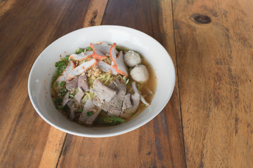 Close up thai spicy pork noodle with big egg.
