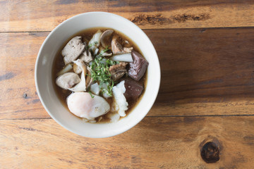 Close up crunchy pork soup with big egg.