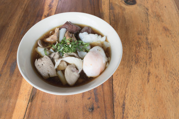 Close up crunchy pork soup with big egg.