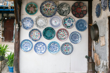White wall decorated with many ceramic plates