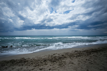 sand beach with turquiose sea and clouds