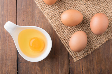 Fresh eggs on wood background. Top view