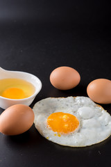 fried eggs on black background, egg