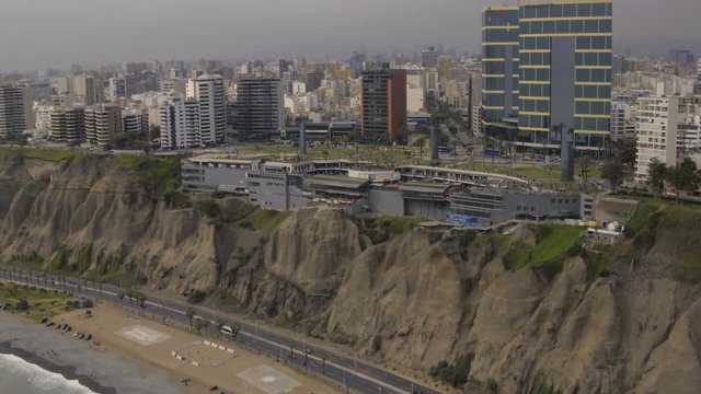 Lima Peru Aerial v3 Flying low besides Larcomar Mall and beach in Miraflores.