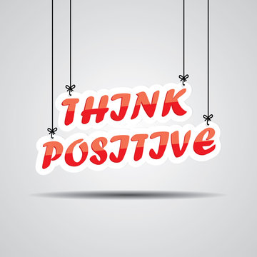 Think positive Sign Hanging On Gray Background.
