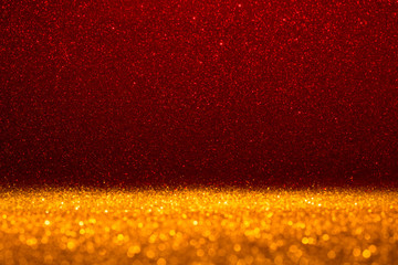 Abstract background filled with shiny gold and red glitter