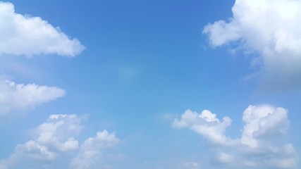 Fototapeta na wymiar Clear blue sky with soft white clouds