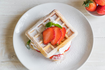 waffle with strawberry on wood
