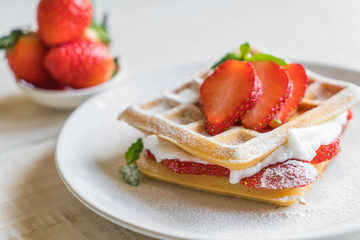 waffle with strawberry on wood