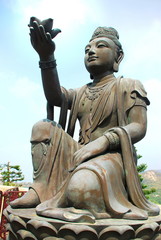 Fototapeta premium One of six statue Puja Bodhisattva at foot of Tian Tan giant Buddha Po Lin Monastery, Ngong Ping, Lantau Island, Hong Kong, China