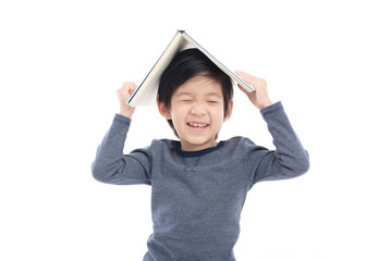 Asian boy with book on head