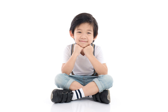 asian boy sitting on white background