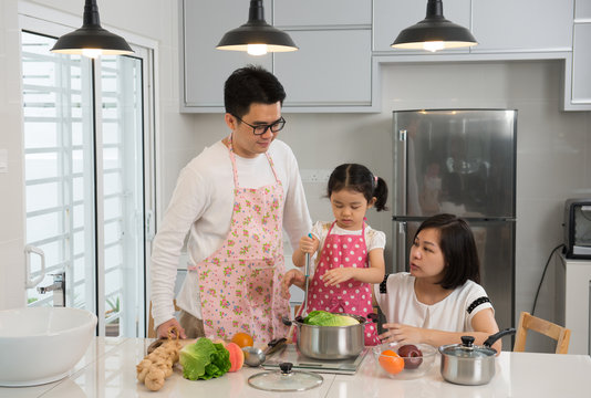 Asian Family Cooking At Kitchen