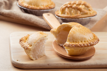 pie and tart with coconut filling on the wooden background - soft focus