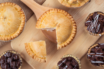 pie and tart with coconut filling on the wooden background - soft focus