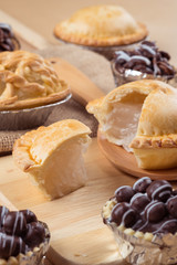 pie and tart with coconut filling on the wooden background - soft focus