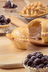 pie and tart with coconut filling on the wooden background - soft focus