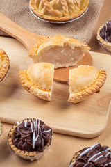 pie and tart with coconut filling on the wooden background - soft focus