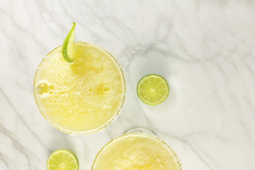Lemon Margarita cocktails with limes and copy space