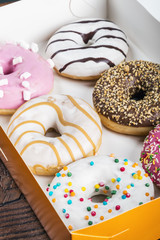 glazed donuts with different fillings in the box