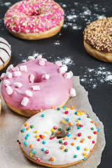 glazed donuts with different fillings on a black background