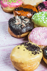 glazed donuts with different fillings on the wooden table