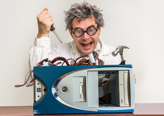 Crazy engineer or scientist repairing computer © andriano_cz