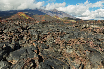 Lava field at Tolbachik volcano, after eruption in 2012 on background Plosky Tolbachik volcano,...