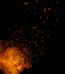 Fototapeta na wymiar sparks of fire on a black background